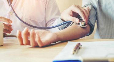 Doctor Measuring arterial blood pressure woman patient on right arm Health care in hospital