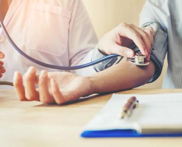 Doctor Measuring arterial blood pressure woman patient on right arm Health care in hospital