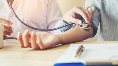 Doctor Measuring arterial blood pressure woman patient on right arm Health care in hospital