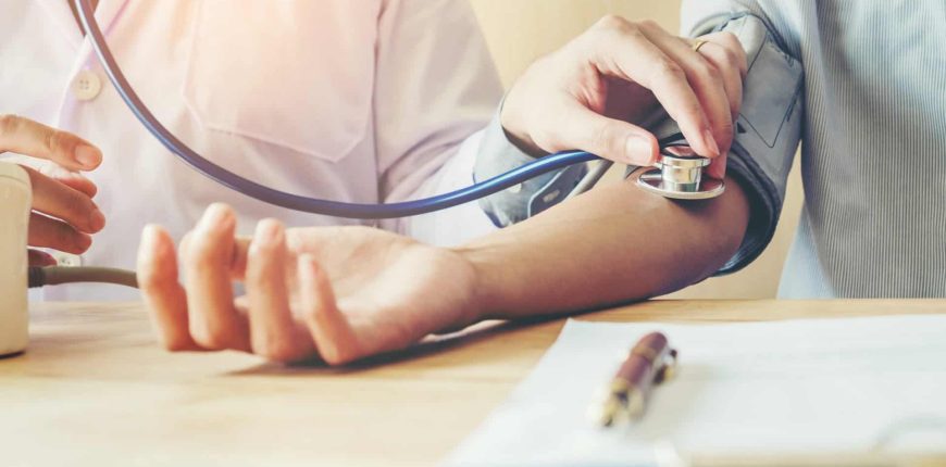 Doctor Measuring arterial blood pressure woman patient on right arm Health care in hospital